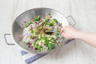 Cook vegetables with spices in the wok