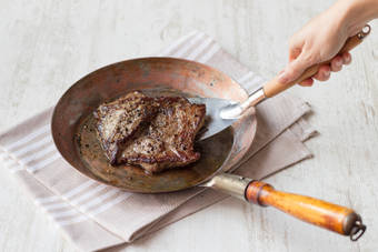 Steak in frying pan when cooked