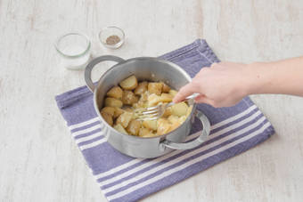 Lightly crush the potatoes with the back of a fork