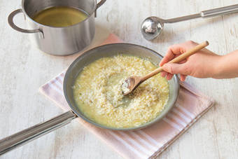Add stock slowly to Arborio rice