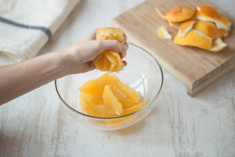 Squeeze juice from orange