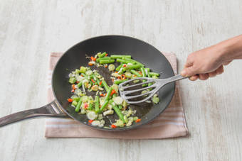 Add your green beans and spring onion to the pan