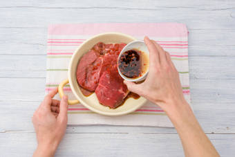 Cover the beef rump steaks in half of the marinade