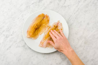 Rub the spice into the fish