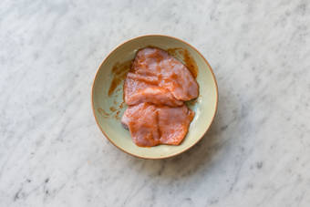 Coat the chicken breast in sauce