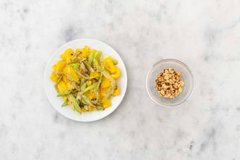 Toast peanuts and cook veggies