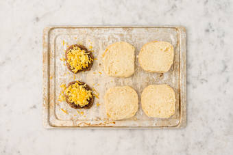 Toast buns and melt cheese