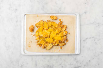 Melt cheese on potatoes