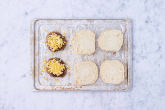 Toast buns and melt cheese