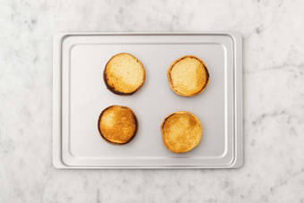 Toast buns and prep dressing