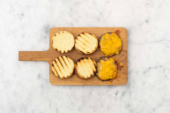 Toast buns and melt cheese