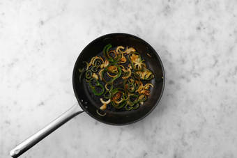 Cook poblanos and onions