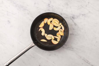 Sauté apples and cook chicken