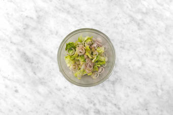 Dress lettuce and shallots