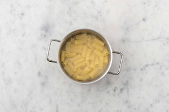 Cook rigatoni and bacon