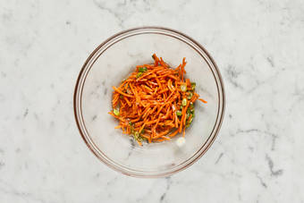 Cook zucchini and make carrot slaw