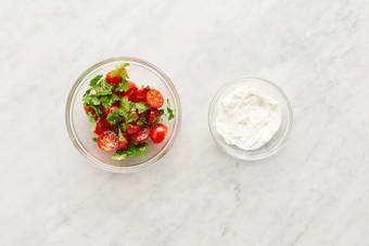 Marinate tomatoes and make crema