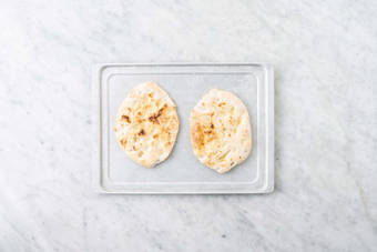 Toast flatbreads and cook chicken