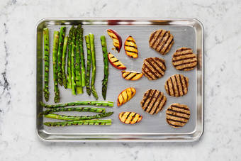 Grill patties, fruit and asparagus