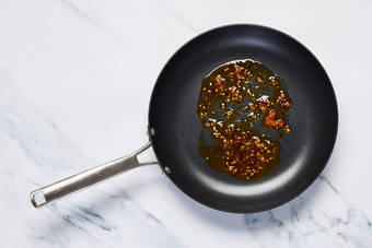 Toast walnuts and make orange-hot honey sauce