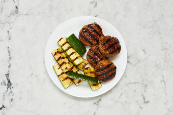 Grill patties and zucchini