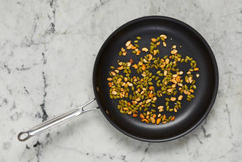 Toast cashews and seeds