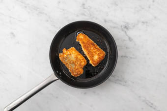 Cook the crumbed basa