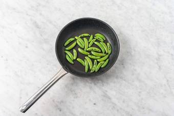 Cook snap peas 