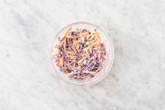 Make lime crema and mix coleslaw
