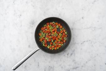 Toast peanuts and cook veggies