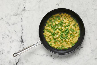 Cook potatoes and peas