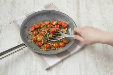 Cook tomatoes until they start to burst