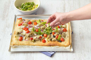 Top the flatbread with dressed romaine