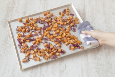 Place onion and sweet potato on baking tray