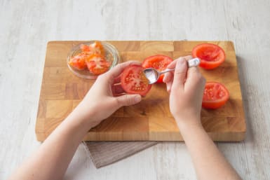 Use a teaspoon to remove the tomato seeds