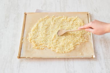 Spread bulgur wheat onto a baking tray