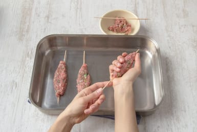 Squeeze meat onto skewers