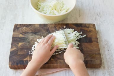 Finely shred the white cabbage