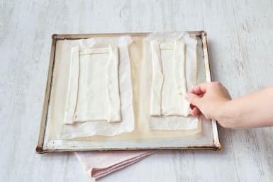 Lay your pastry on a tray and score the edges.