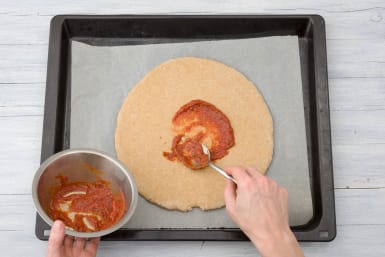 Spread the pizza bases with the tomato paste