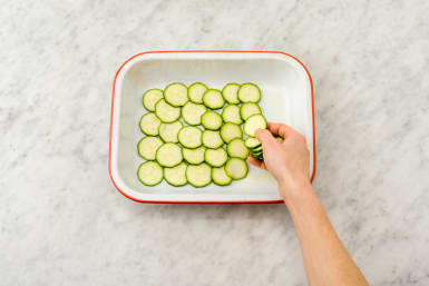 Layer the courgettes in the dish