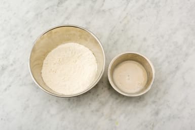 Mix the yeast with water and put the flour in a bowl