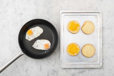 Fry eggs and broil buns
