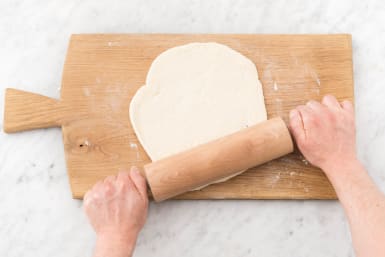 Roll pizza dough.