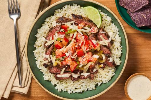 HFRC-R15476EPU05_Hero_CheesyChickenFajitaBowlWithBlueCornChipsPicoDeGalloAndChiliLimeCrema_W06-112-2026-df5608c4