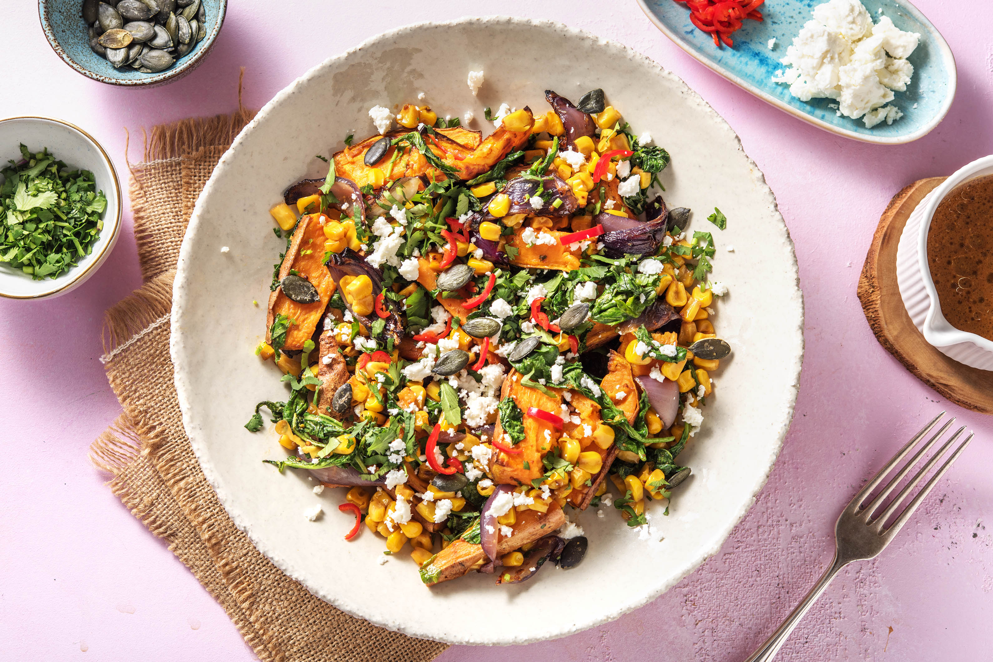 Roasted sweet potato and charred corn salad with miso dressing and feta