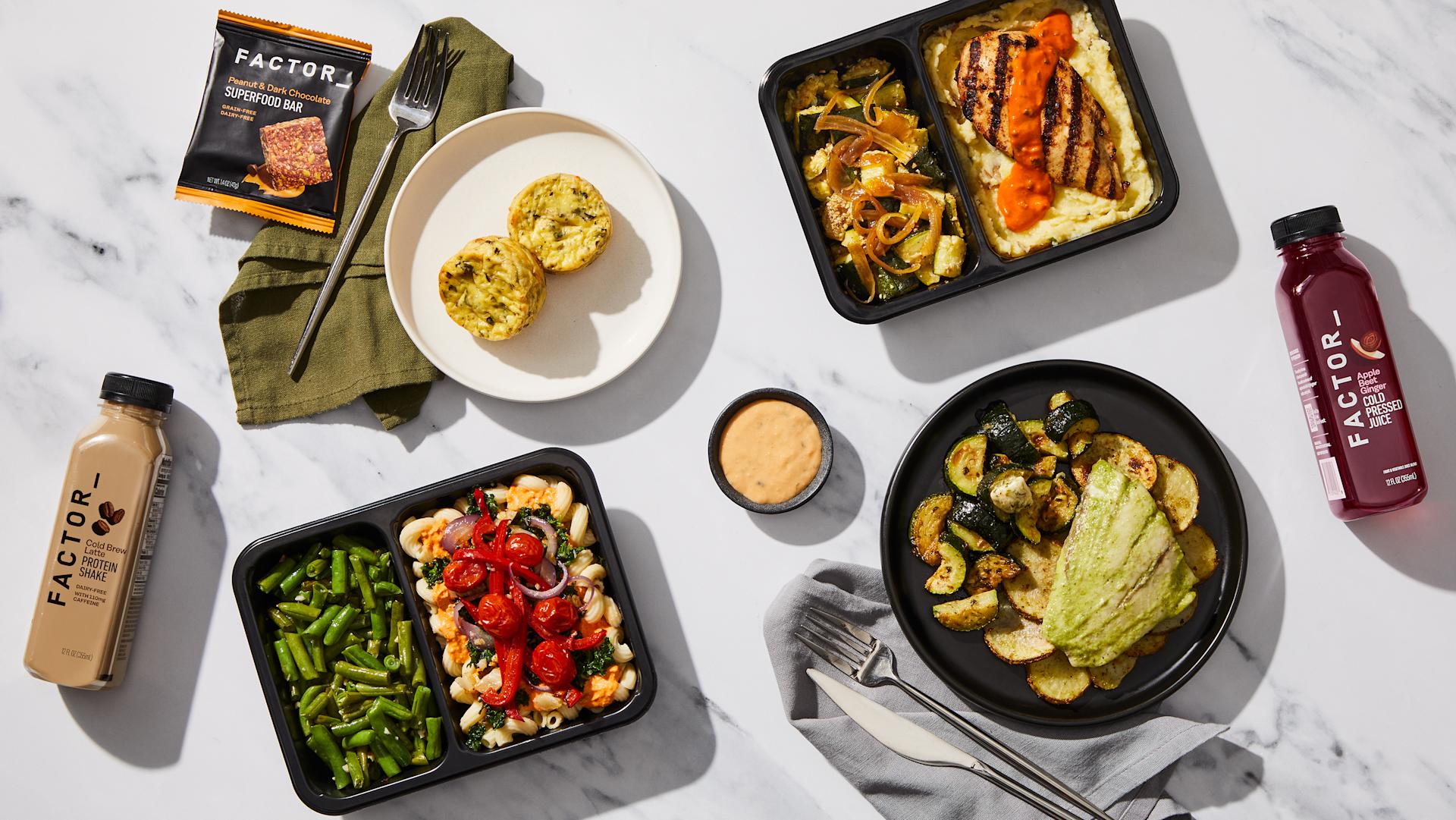 Factor meal tray with pasta and green beans, served with egg bites, a protein shake, and a superfood bar.