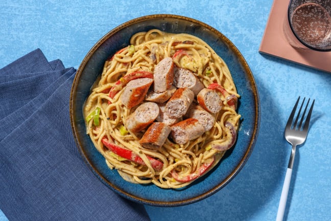 Volkoren spaghetti met gekruide kipworst en pesto-roomsaus