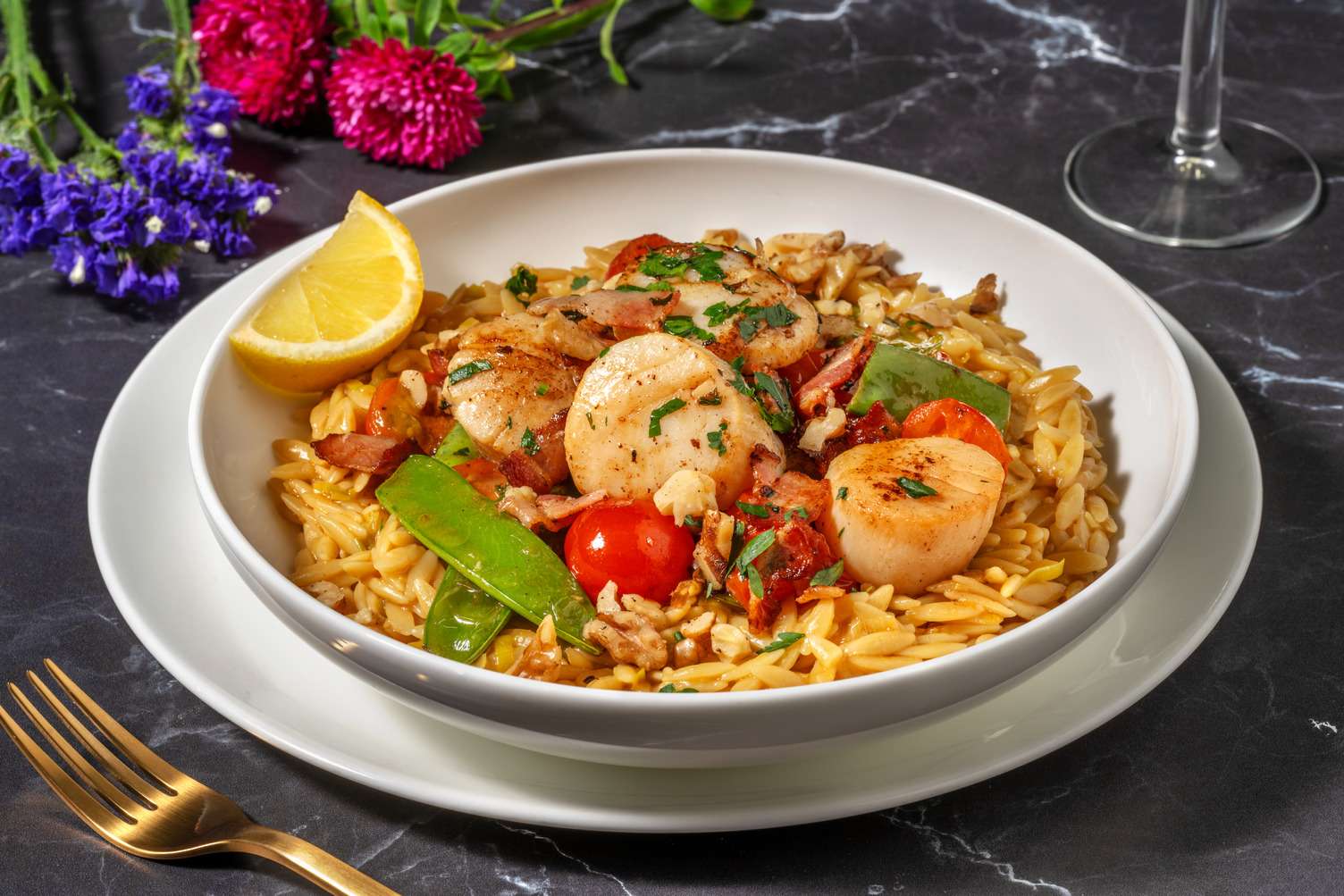 Pétoncles au beurre de citron sur orzo au bacon et aux poireaux