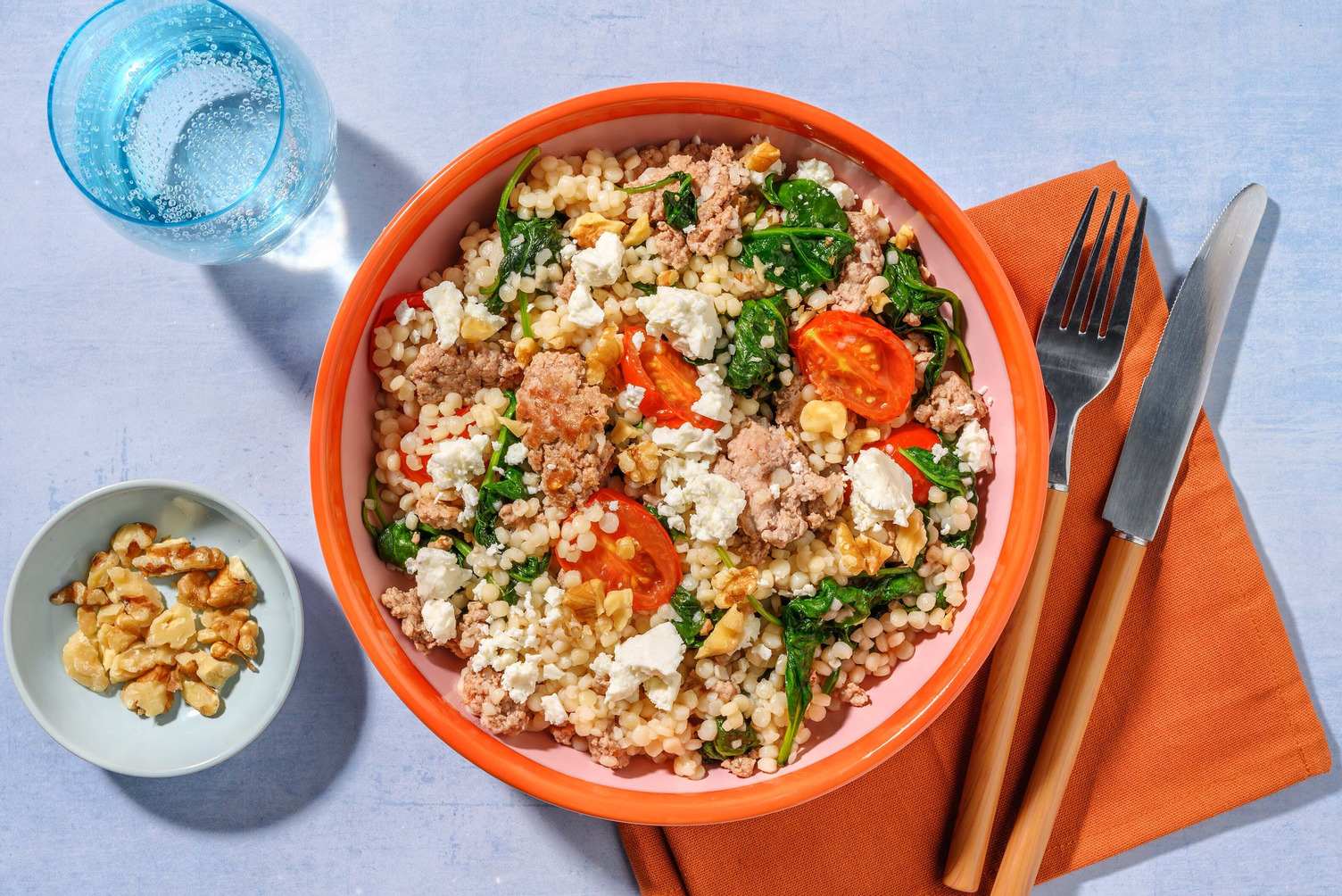 Maiale saltato, couscous perlato e spinaci
